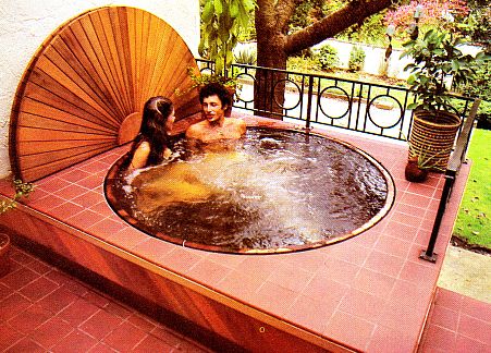 A couple having a date in a hot tub.