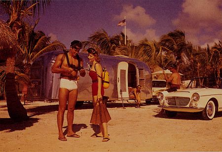 Postcard of Airstream trailer on a beach in 1960.
