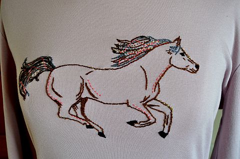 Close-up of horse embroidery on t-shirt.