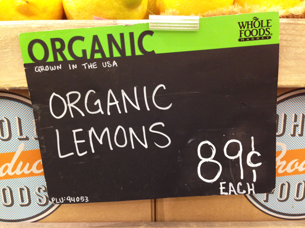 Whole Foods sign for organic lemons 89 cents each